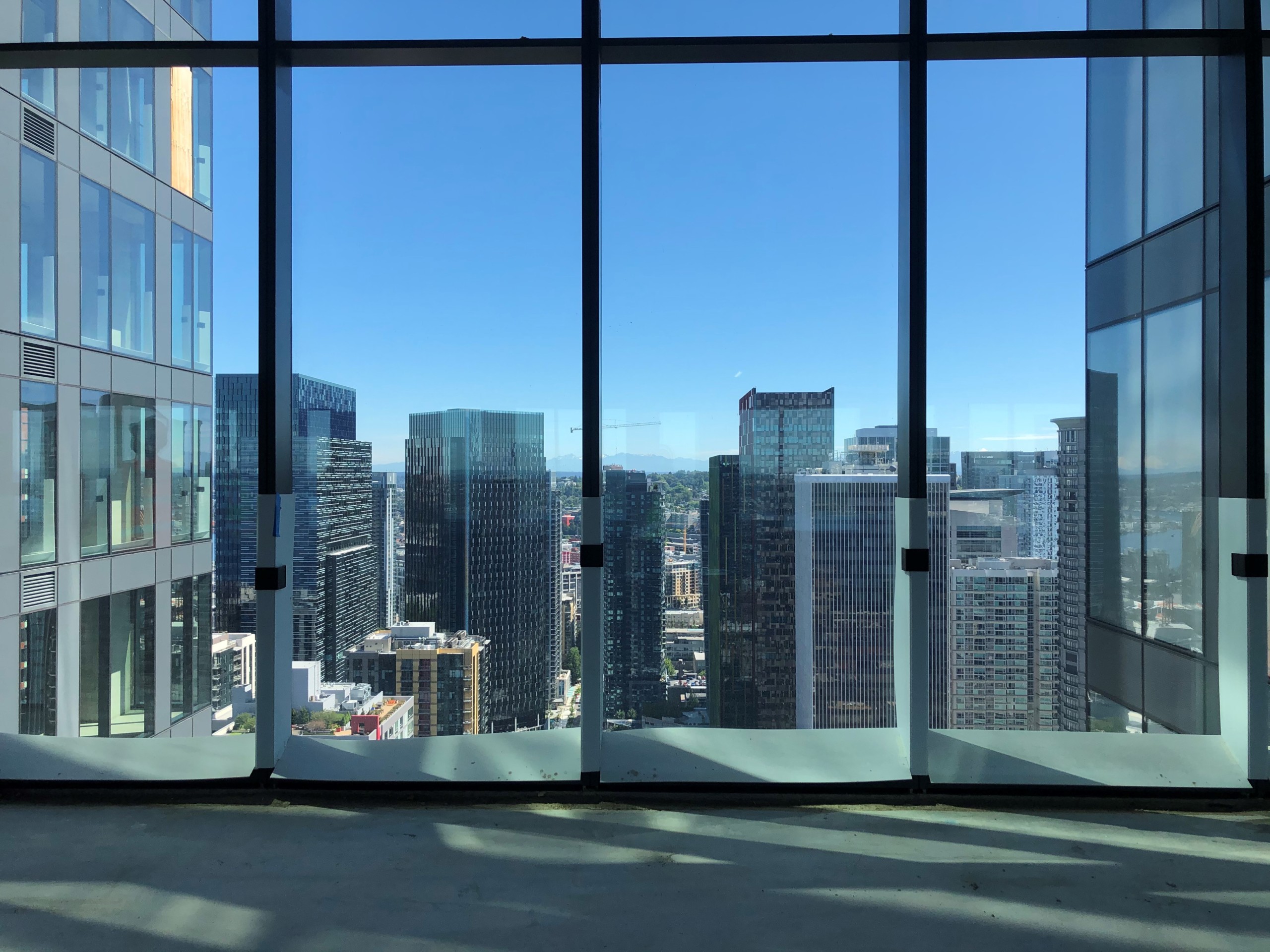 View of city skyscrapers from glass windows